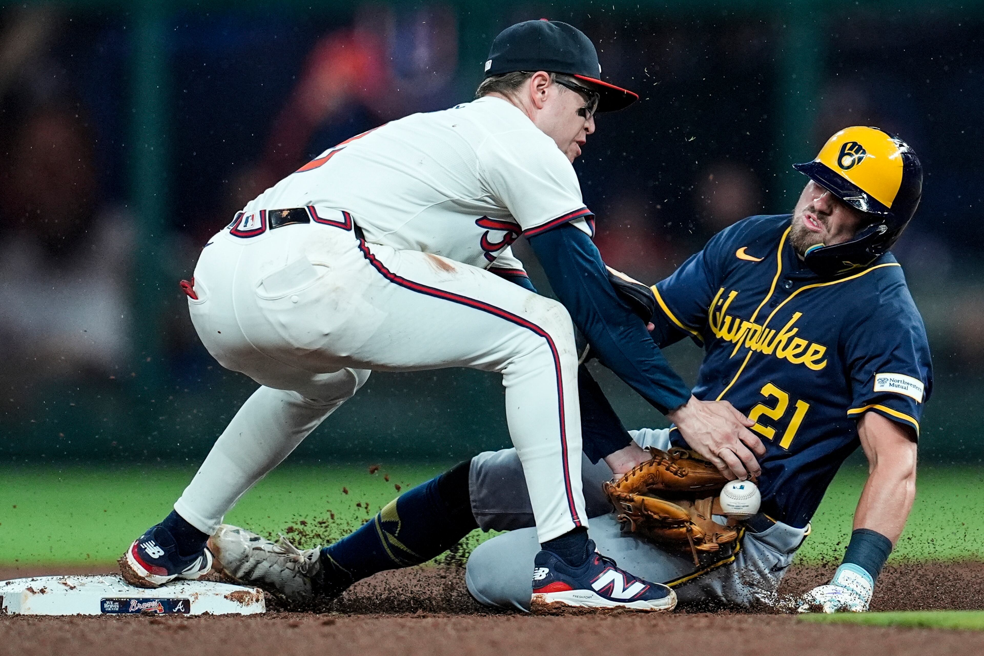 Milwaukee Brewers' Caleb Durbin (21) steals the base against Atlanta Braves shortstop Nick Allen (2) in the fifth inning of a baseball game, Tuesday, Aug. 5, 2025, in Atlanta. (AP Photo/Mike Stewart)
