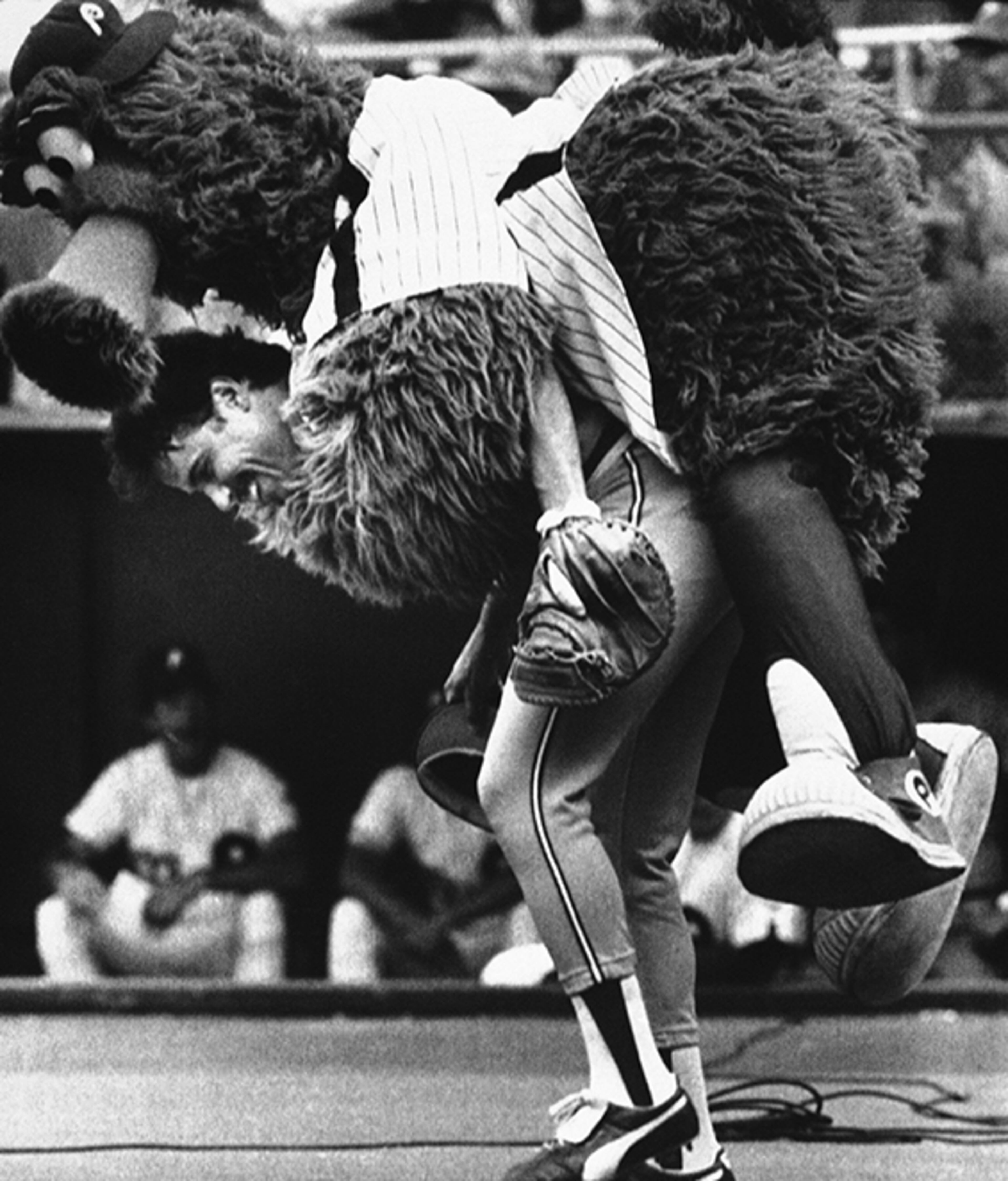 MAY 25 - Braves catcher Biff Pocoroba (pictured: mobbed by the Phillie Phanatic before a game in 1983) was drafted in the 17th round of the 1971 draft. He went on to hit .257/.339/.367 with 21 homers and 172 RBIs over a 10-year career with the club from 1975-84. He earned All-Star honors in 1978. Pocoroba was 66.
