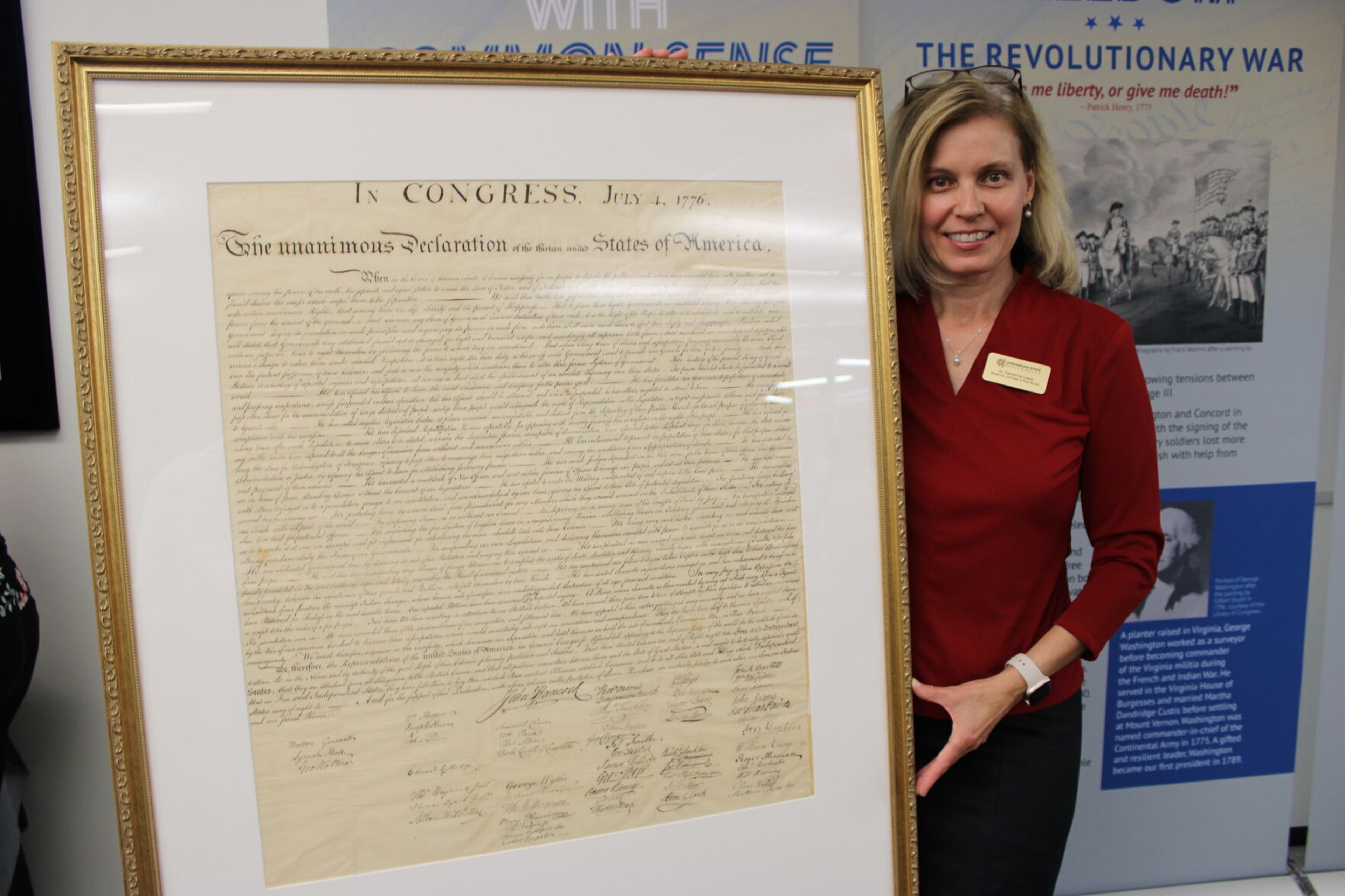 Dr. Catherine Lewis, KSU’s associate vice provost for museums, archives, rare books and the university libraries, with the university’s newly restored copy of the Declaration of Independence from 1843.