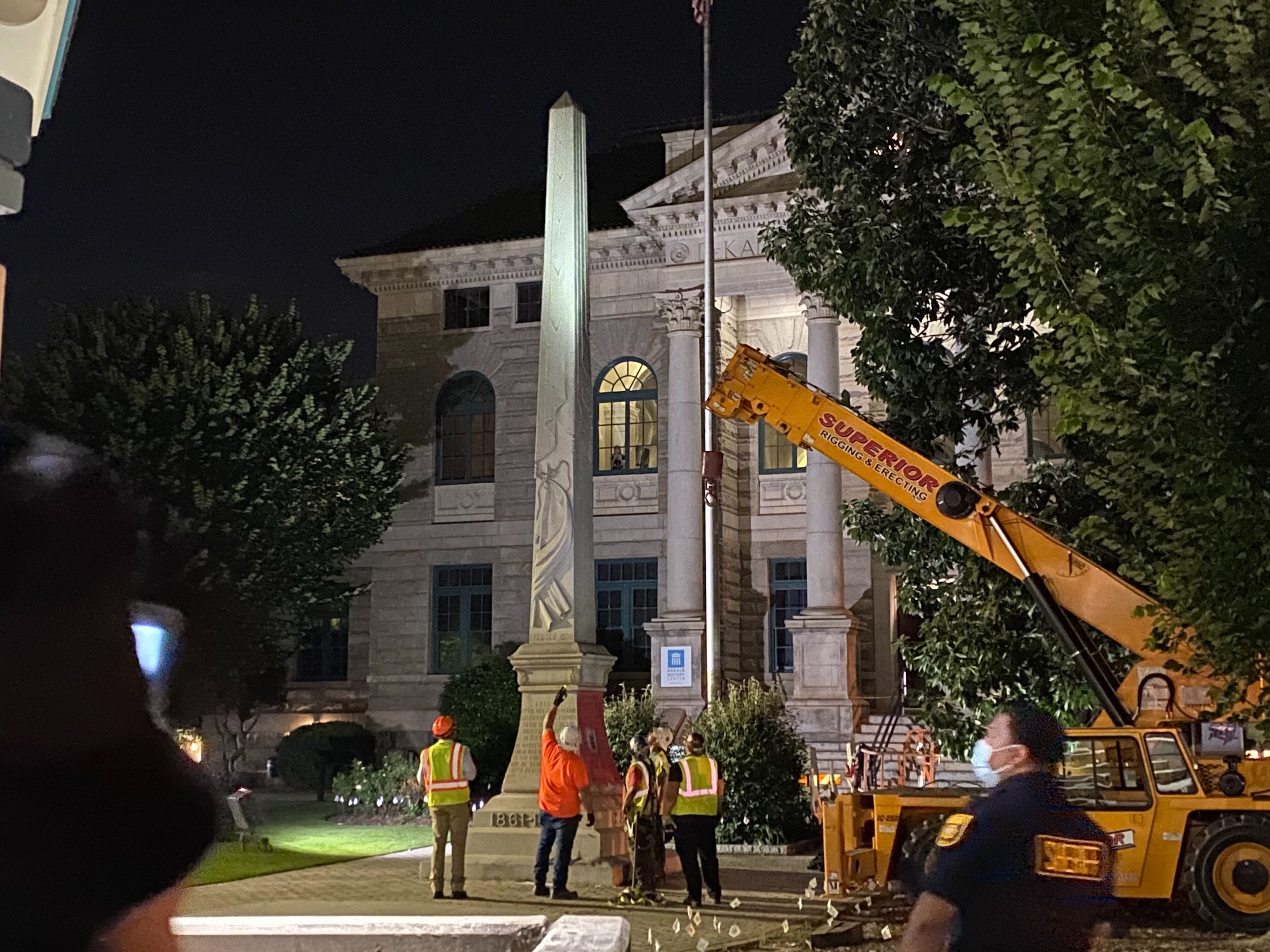 A 30-foot obelisk Confederate moment, which has stood for 112 years, was taken down in the downtown Decatur square late Thursday night. The monument was erected in 1908 by the United Daughters of the Confederacy. Photos by Amanda Coyne / AJC
