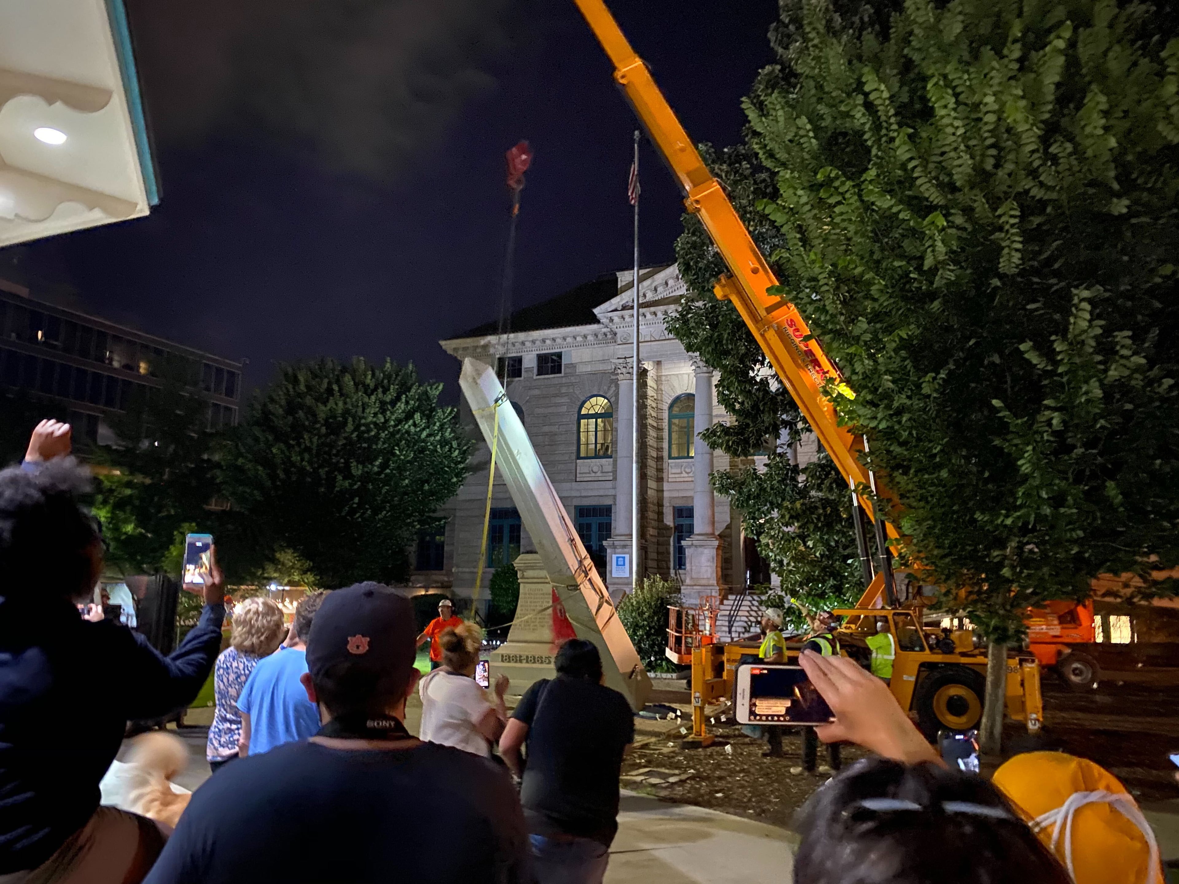 A 30-foot obelisk Confederate moment, which has stood for 112 years, was taken down in the downtown Decatur square late Thursday night. The monument was erected in 1908 by the United Daughters of the Confederacy. Photos by Amanda Coyne / AJC
