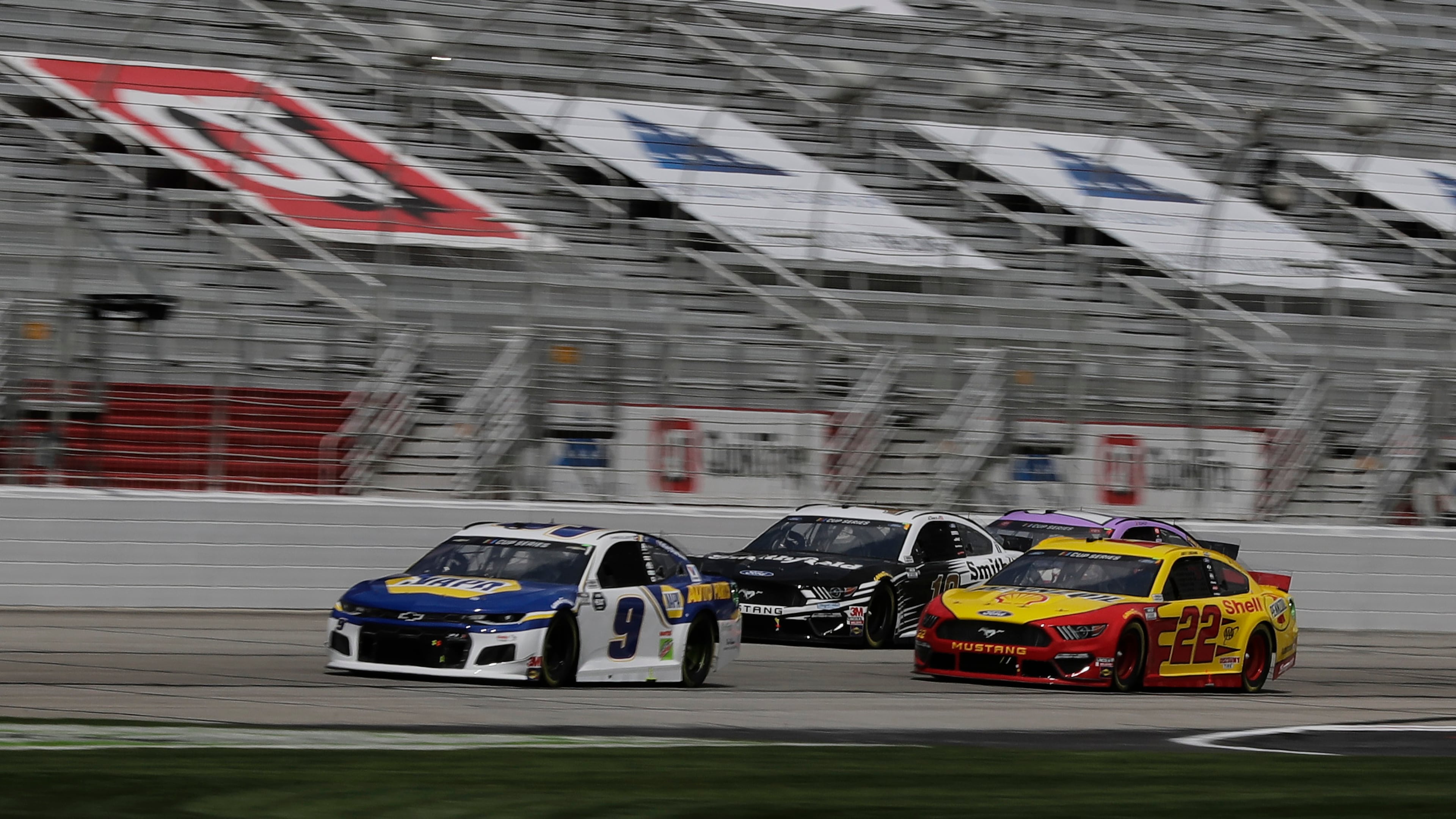 Chase Elliott (9), Aric Almirola (10) and Joey Logano (22) race at an empty Atlanta Motor Speedway during the Folds of Honor QuikTrip 500 race, Sunday, June 7, 2020, in Hampton, Ga. The race was postponed due to the coronavirus pandemic.