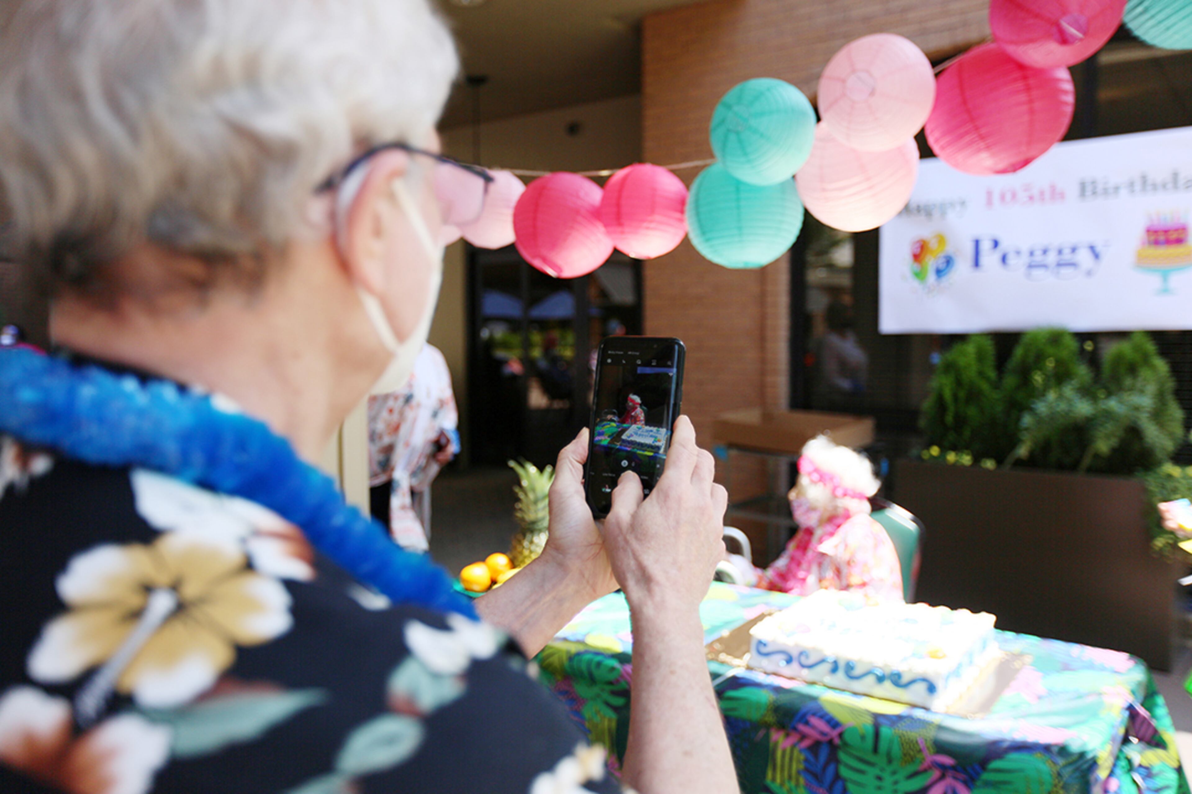 Bill Cobb, 72, of Decatur, takes a photo of his mother, Peggy Cobb, during the celebration of her birthday at the Hammond Glen Retirement Community on Friday, May 22, 2020. (Photo: Miguel Martinez for The Atlanta Journal-Constitution)