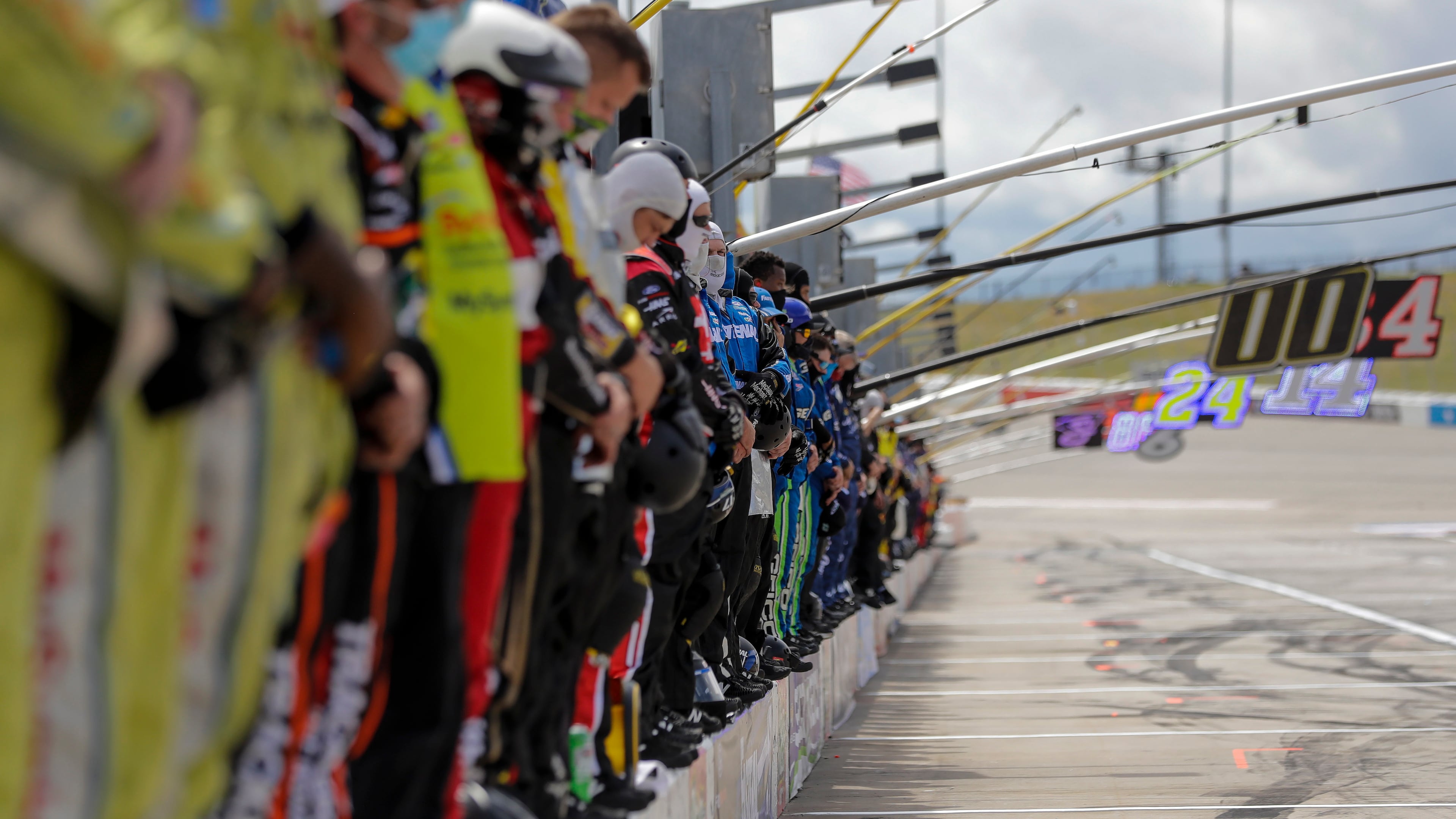 Crew members stand on pit wall for a moment of silence before the Folds of Honor QuikTrip 500 NASCAR race Sunday, Jun 7, 2020, at Atlanta Motor Speedway in Hampton, Ga. NASCAR paused before Sunday's Cup race at Atlanta Motor Speedway to acknowledge the country's social unrest.