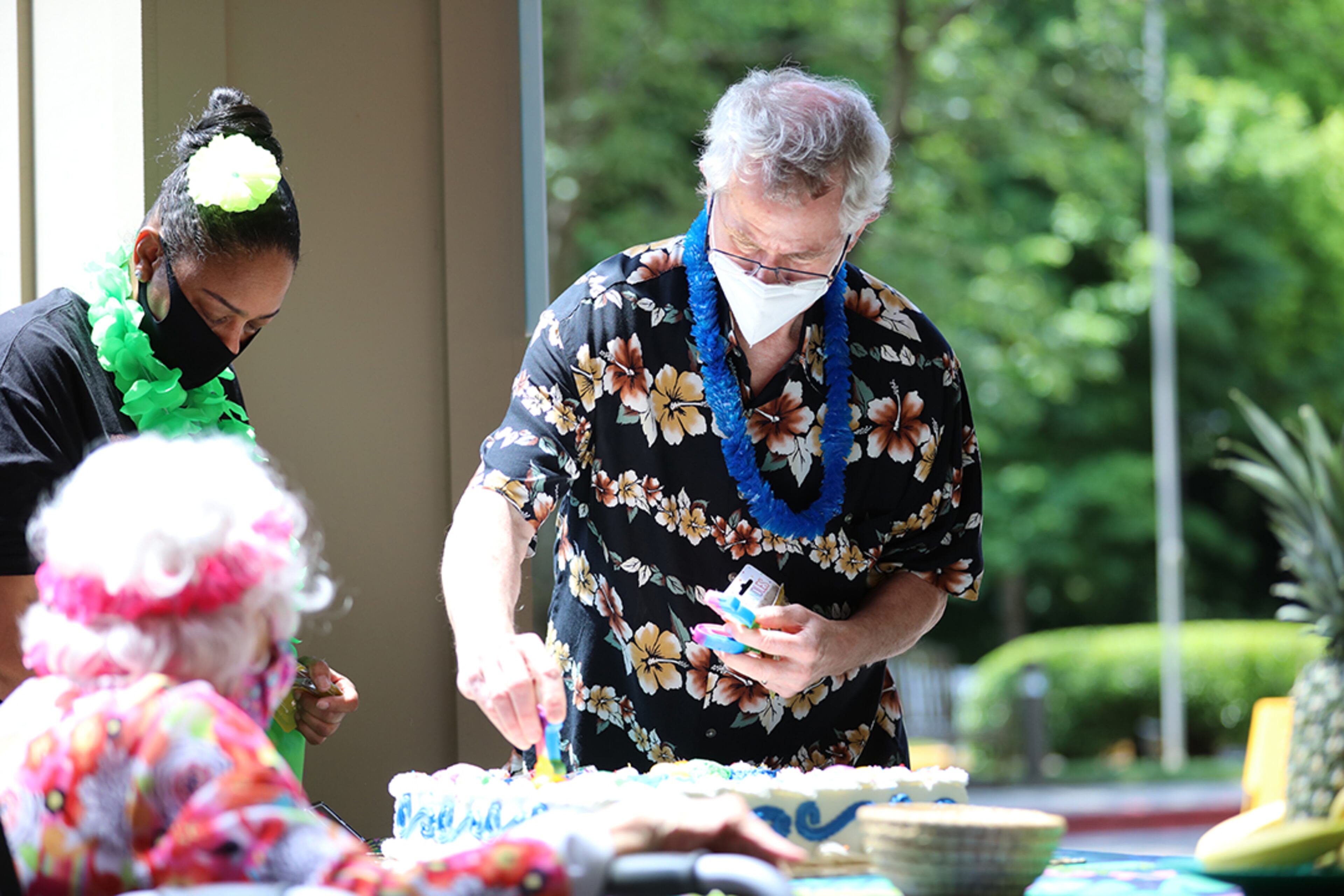 Peggy Cobb's son Bill Cobb and Hammond Glen staff member April Parker put the candles on Peggy's birthday cake during the celebration of her 105th birthday at the Hammond Glen Retirement Community on Friday, May 22, 2020. (Photo: Miguel Martinez for The Atlanta Journal-Constitution)