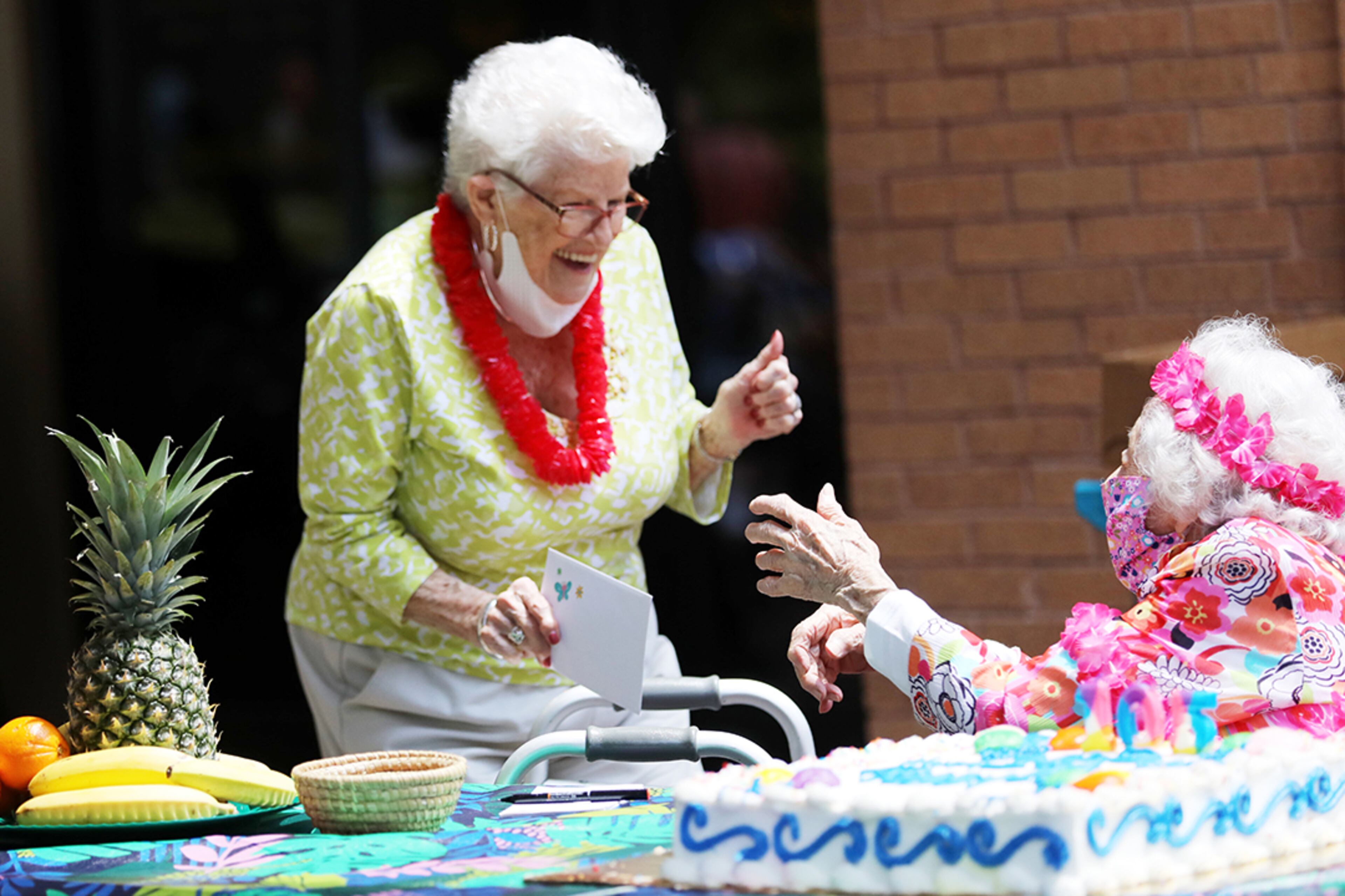 Fellow resident Helen Allan, 86 (left), celebrates with Peggy Cobb during her birthday gathering at the Hammond Glen Retirement Community on Friday, May 22, 2020. (Photo: Miguel Martinez for The Atlanta Journal-Constitution)